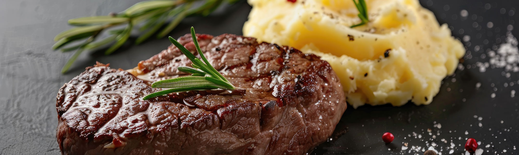 Beef Steak With Mashed Potatoes On A Black Background